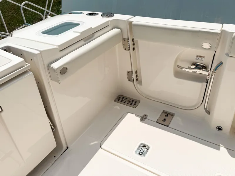 Slide: The Image of 2022 Pursuit S 328 Sport boat interior, featuring sleek white design and modern fixtures. - 12