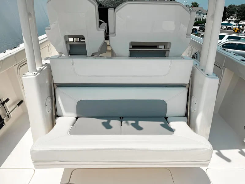 Slide: The Image of 2022 Pursuit S 328 Sport boat interior with white cushioned seating. - 14