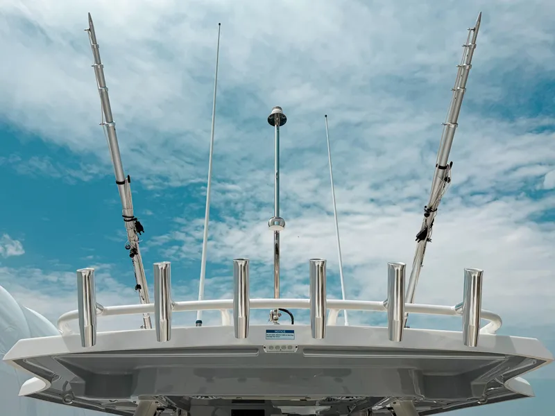 Slide: The Image of 2022 Pursuit S 328 Sport boat with fishing rods against a cloudy sky. - 17