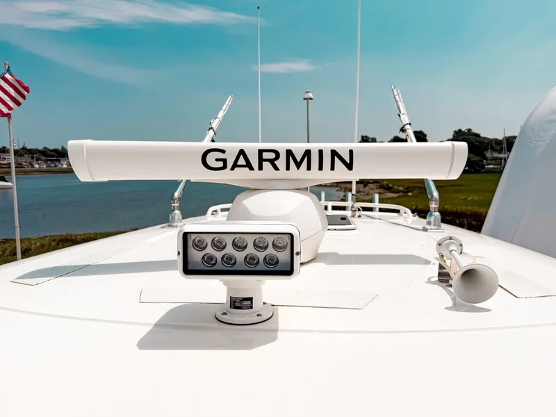 Slide: The Image of 2022 Pursuit S 328 Sport boat with Garmin radar and American flag in background. - 18