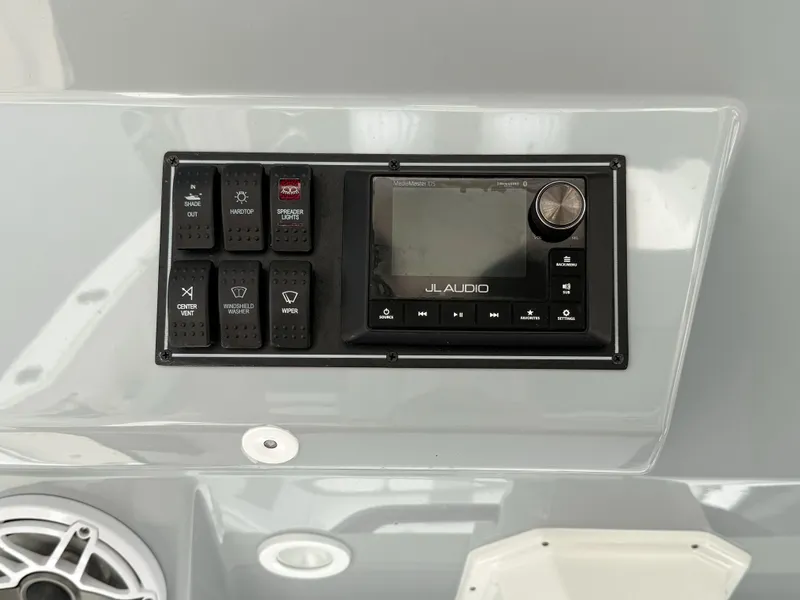 Slide: The Image of Control panel of 2022 Pursuit S 328 Sport boat with JL Audio system. - 23