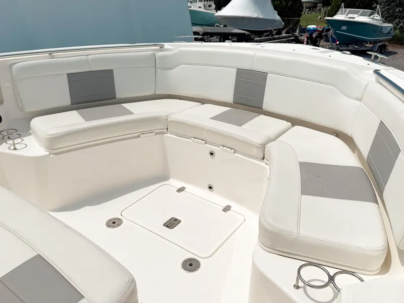 Slide: The Image of 2022 Pursuit S 328 Sport boat with spacious white and gray seating area. - 27