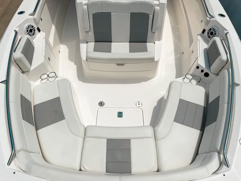 Slide: The Image of 2022 Pursuit S 328 Sport boat interior with gray and white seating and cup holders. - 28