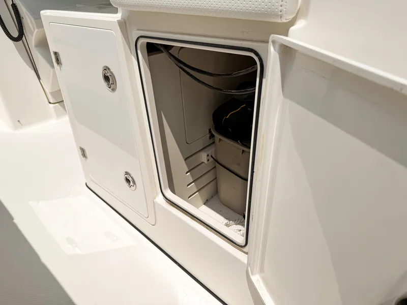 Slide: The Image of 2022 Pursuit S 328 Sport boat storage compartment with open hatch. - 31