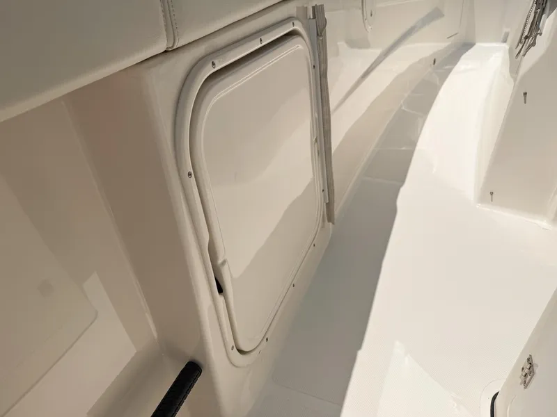 Slide: The Image of 2022 Pursuit S 328 Sport boat interior with storage compartment. - 32