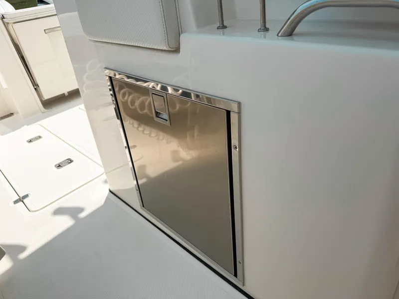 Slide: The Image of Stainless steel compartment on 2022 Pursuit S 328 Sport boat deck. - 33