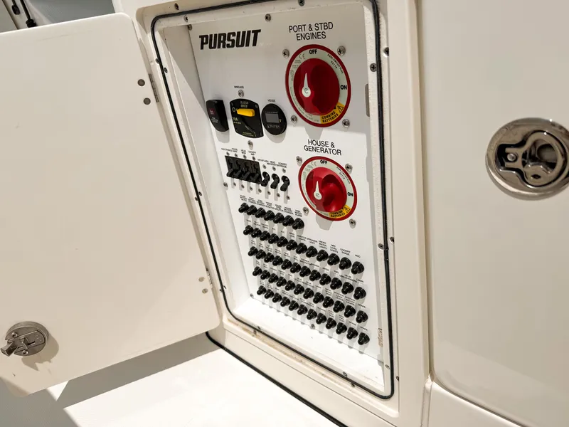 Slide: The Image of Electrical panel of 2022 Pursuit S 328 Sport boat with switches and controls. - 34