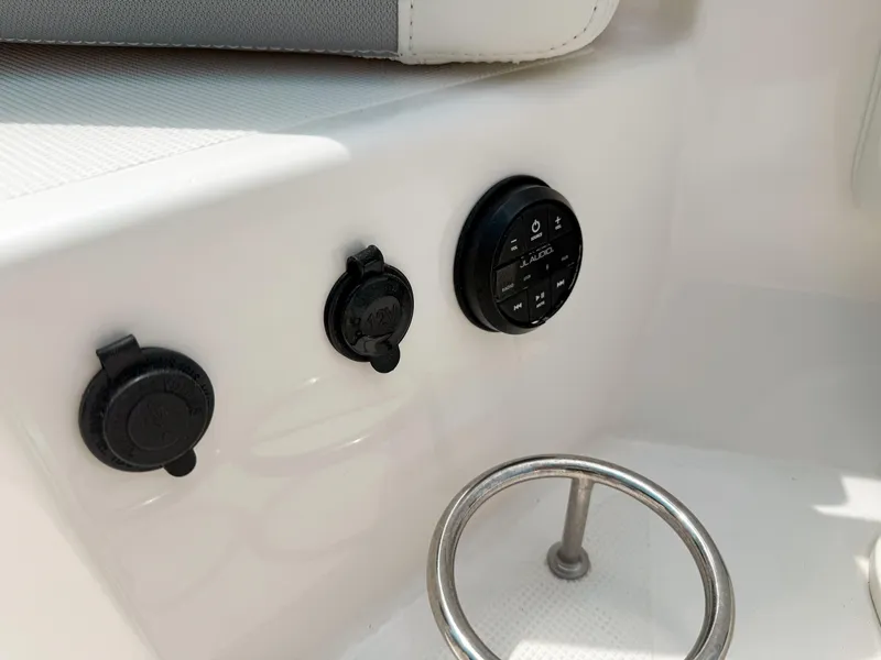 Slide: The Image of Control panel on 2022 Pursuit S 328 Sport boat, featuring buttons and a metal handle. - 36