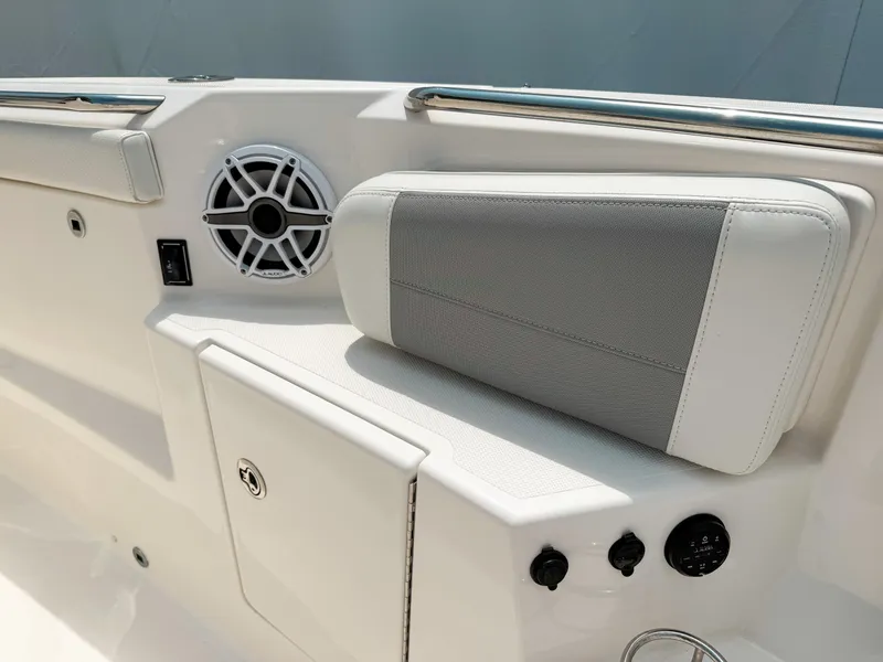 Slide: The Image of 2022 Pursuit S 328 Sport boat interior with speaker and cushioned seating. - 37