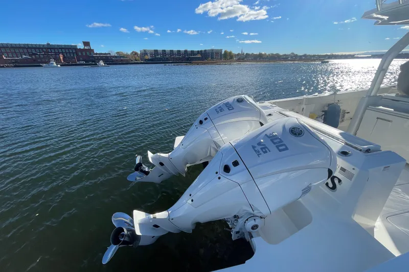 Slide: The Image of 2022 Pursuit S328 boat with dual outboard engines on a sunny day. - 39