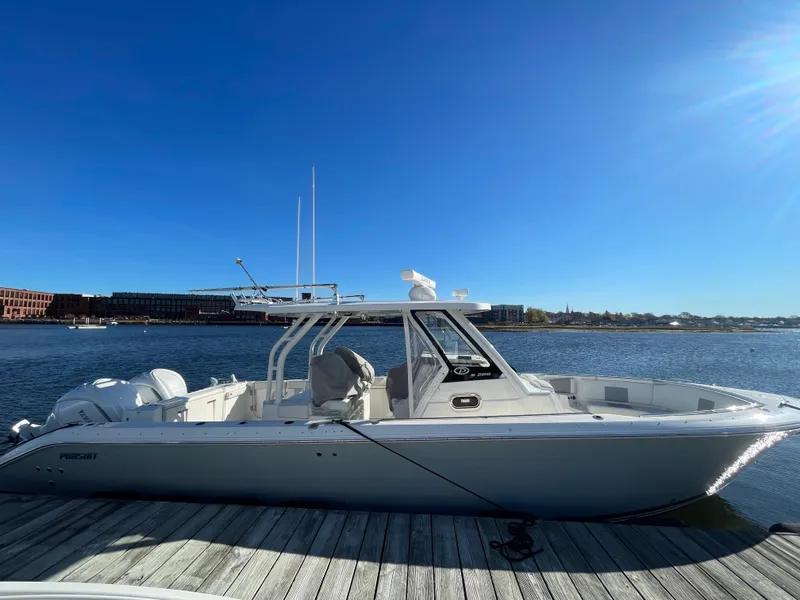Slide: The Image of 2022 Pursuit S328 boat docked on a sunny day by the water. - 47