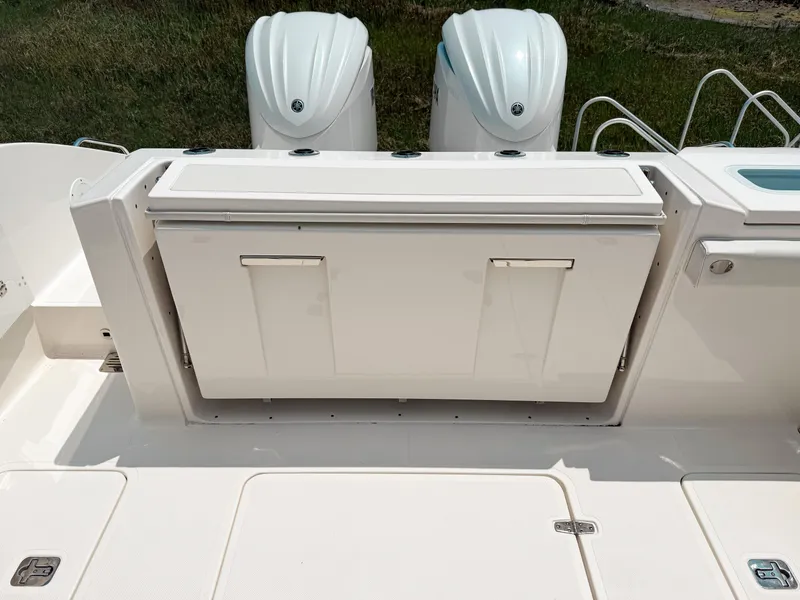 Slide: The Image of 2022 Pursuit S 328 Sport boat with dual outboard engines and storage compartment. - 9