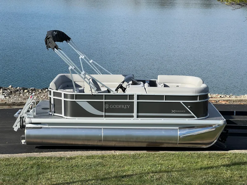 Slide: The Image of 2025 Godfrey Xperience 1880 CX pontoon boat by a serene lake. - 1