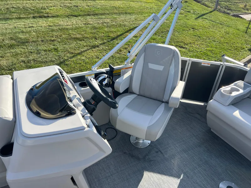 Slide: The Image of 2025 Godfrey Xperience 1880 CX boat interior with steering wheel and captain's chair. - 12