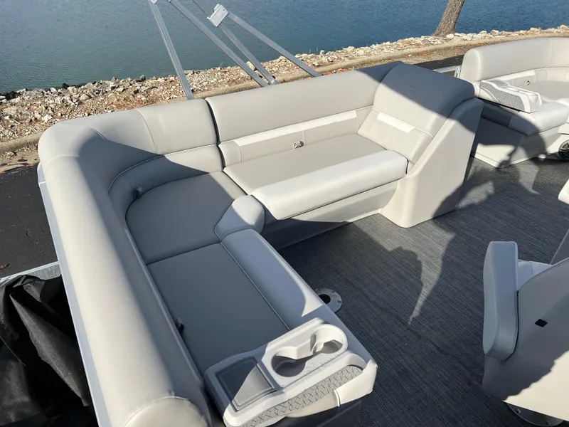 Slide: The Image of 2025 Godfrey Xperience 1880 CX pontoon boat interior with gray seating and cup holders. - 14