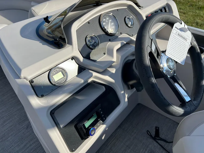 Slide: The Image of 2025 Godfrey Xperience 1880 CX boat dashboard with steering wheel and gauges. - 16