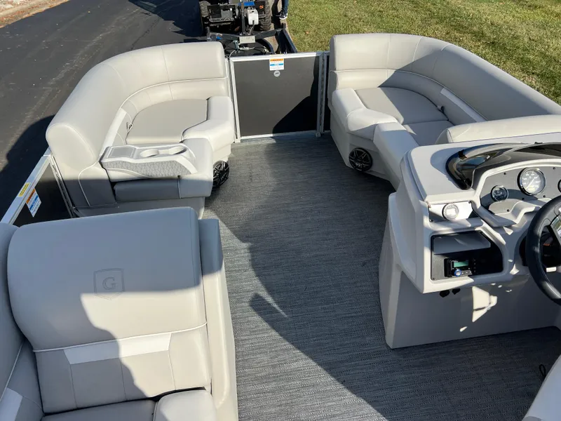 Slide: The Image of 2025 Godfrey Xperience 1880 CX pontoon boat interior with plush seating and modern dashboard. - 18