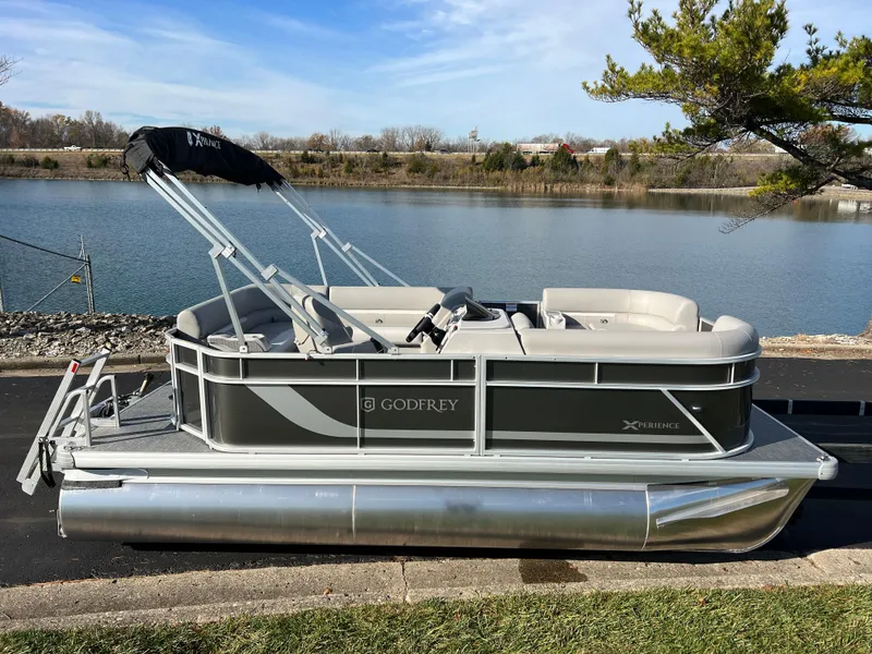 Slide: The Image of 2025 Godfrey Xperience 1880 CX pontoon boat by a serene lake. - 4
