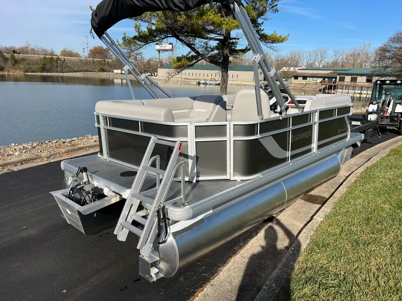 Slide: The Image of 2025 Godfrey Xperience 1880 CX pontoon boat by a lakeside on a sunny day. - 5