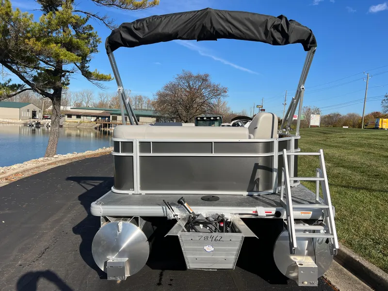 Slide: The Image of 2025 Godfrey Xperience 1880 CX pontoon boat, docked by a serene lakeside. - 6