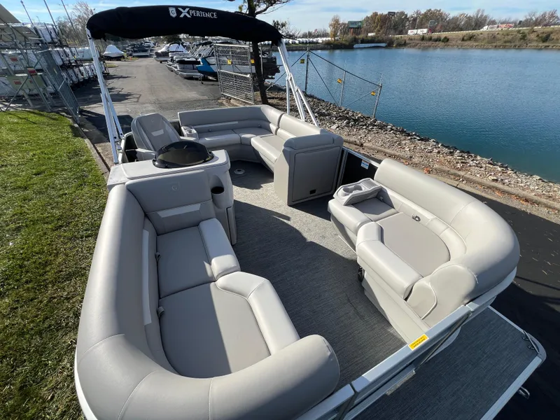 Slide: The Image of 2025 Godfrey Xperience 1880 CX pontoon boat with spacious seating by a serene lake. - 7