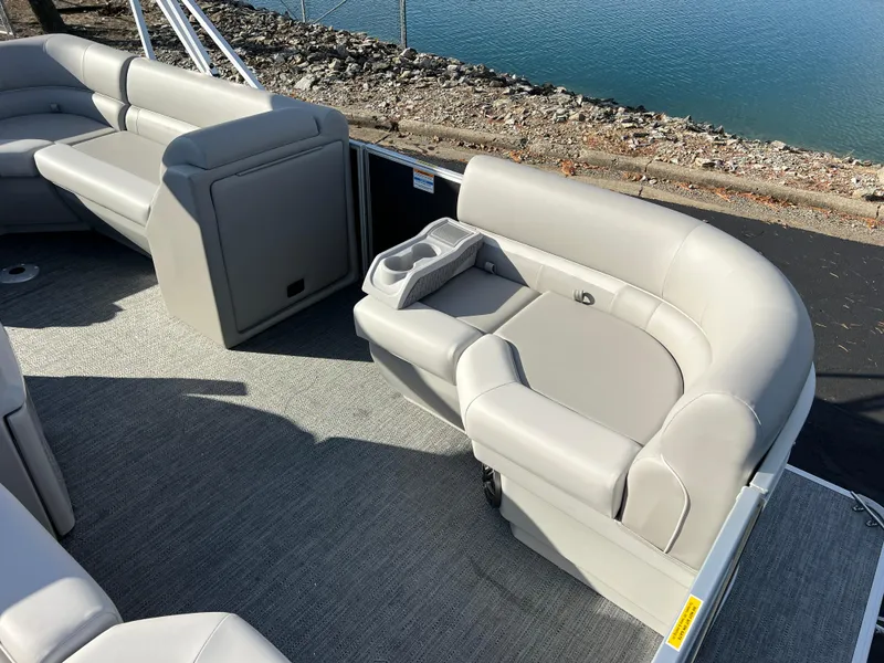 Slide: The Image of 2025 Godfrey Xperience 1880 CX pontoon boat with plush seating by the water. - 8