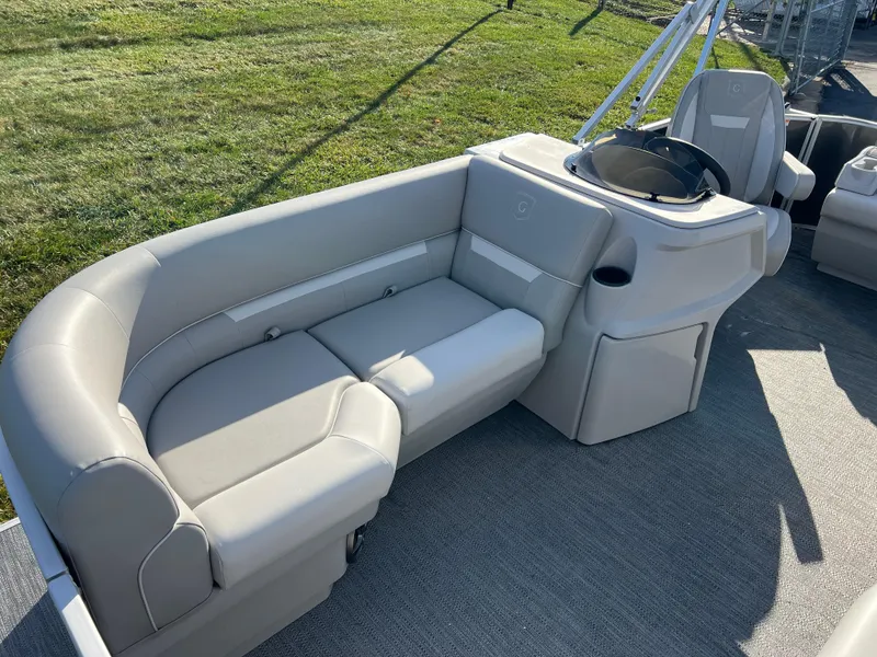 Slide: The Image of 2025 Godfrey Xperience 1880 CX boat interior with gray seating and helm station. - 9