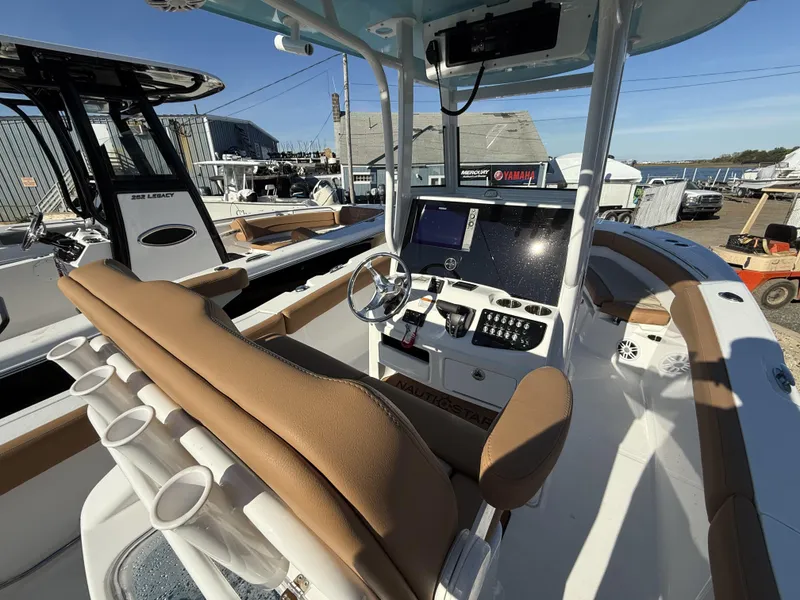 Slide: The Image of 2025 NauticStar 242OS boat interior with modern helm and seating. - 12