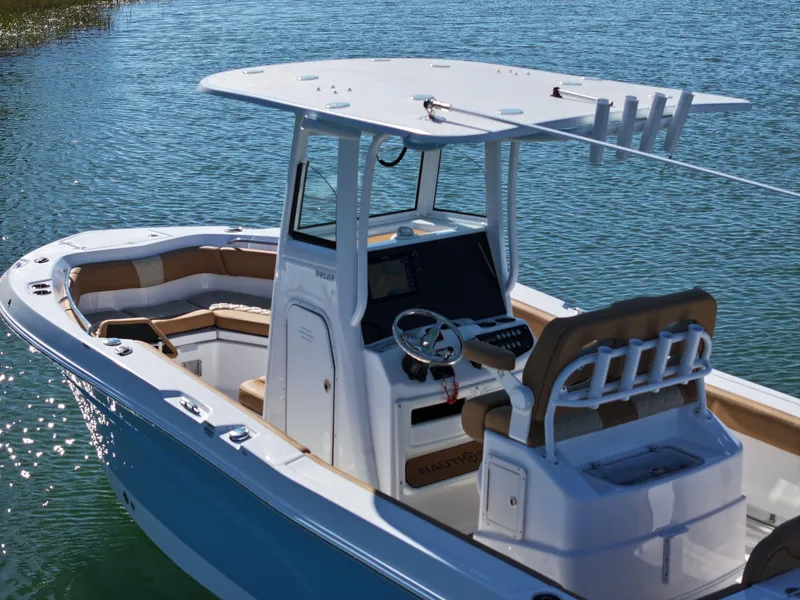 Slide: The Image of 2025 NauticStar 242OS boat on water, featuring sleek design and spacious seating. - 3