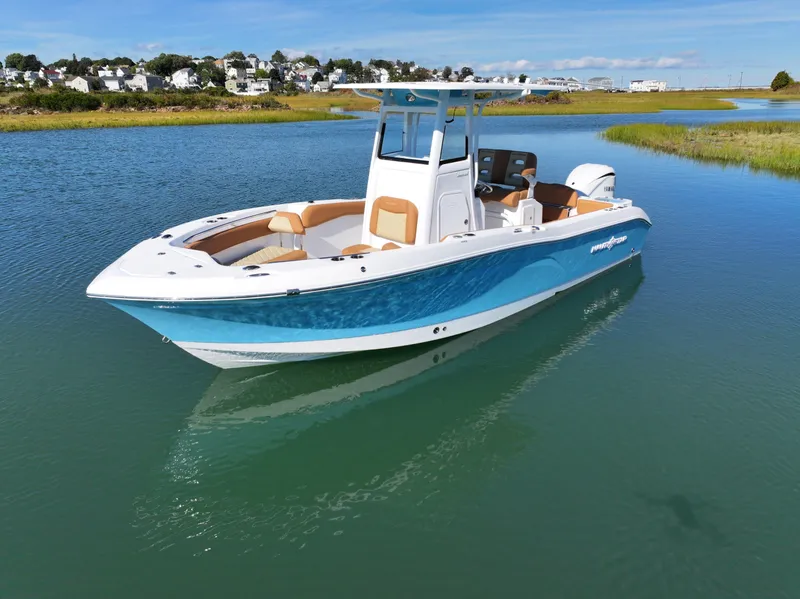 Slide: The Image of 2025 NauticStar 242OS boat on calm water, featuring sleek design and modern amenities. - 9