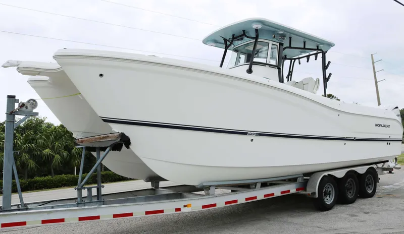 The Image of 2025 World Cat 295CC boat on trailer, white hull, center console design. - 0