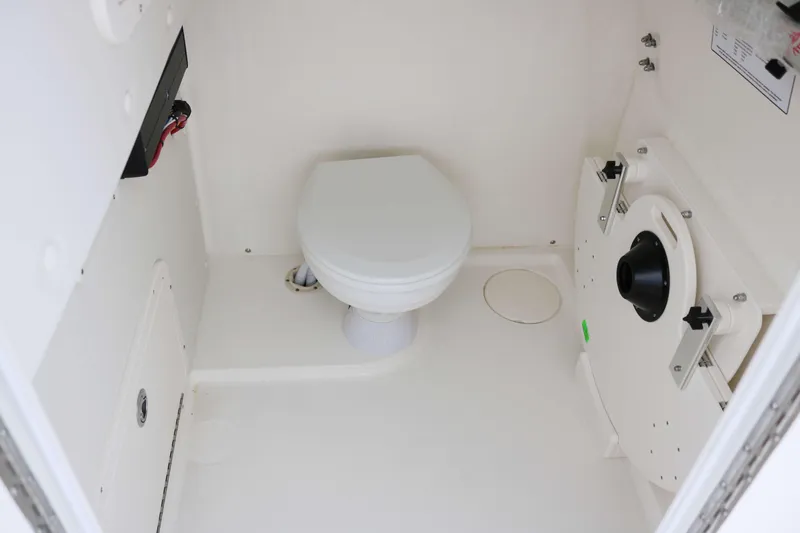 Slide: The Image of 2025 World Cat 295CC boat interior with a compact marine toilet. - 10