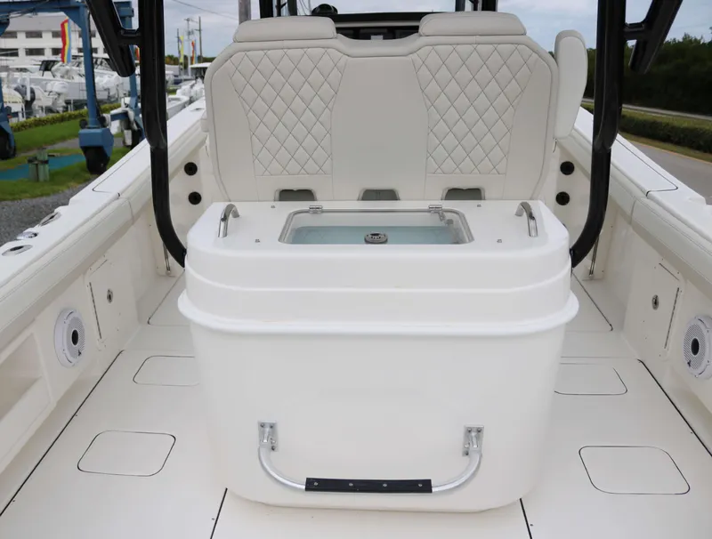 Slide: The Image of 2025 World Cat 295CC boat interior with cushioned seating and storage compartment. - 11