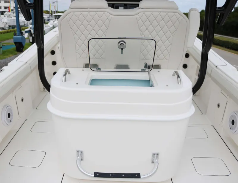 Slide: The Image of 2025 World Cat 295CC boat interior with white seating and storage compartment. - 12
