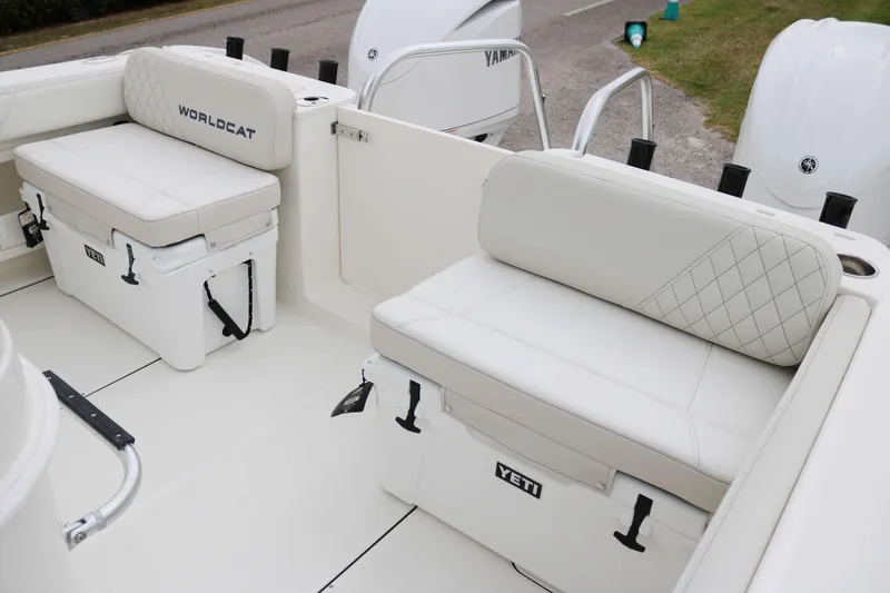 Slide: The Image of 2025 World Cat 295CC boat interior with Yeti coolers and cushioned seating. - 13