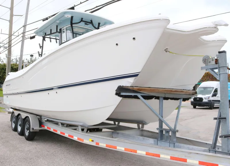Slide: The Image of 2025 World Cat 295CC boat on trailer, showcasing sleek design and modern features. - 2