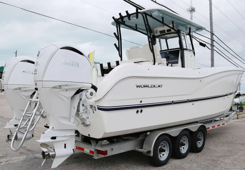 Slide: The Image of 2025 World Cat 295CC boat on trailer, featuring dual outboard engines. - 3