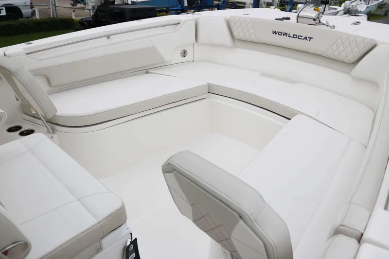 Slide: The Image of 2025 World Cat 295CC boat interior with white cushioned seating. - 8