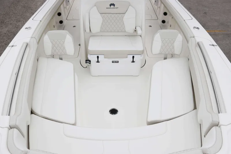 Slide: The Image of 2025 World Cat 295CC boat interior with white seating and storage. - 9
