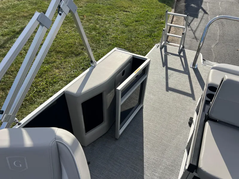 Slide: The Image of 2025 Godfrey XPERIENCE 2286 SFLC boat interior with seating and storage compartments. - 11