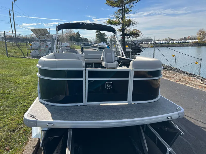 Slide: The Image of 2025 Godfrey XPERIENCE 2286 SFLC pontoon boat docked by a canal. - 3