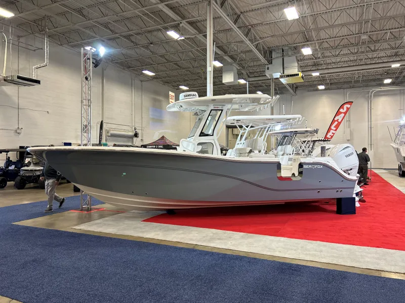 The Image of 2025 Sea Fox 268 Commander boat displayed indoors on red carpet. - 0