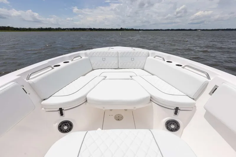Slide: The Image of 2025 Sea Fox 268 Commander boat interior with white cushioned seating on open water. - 12