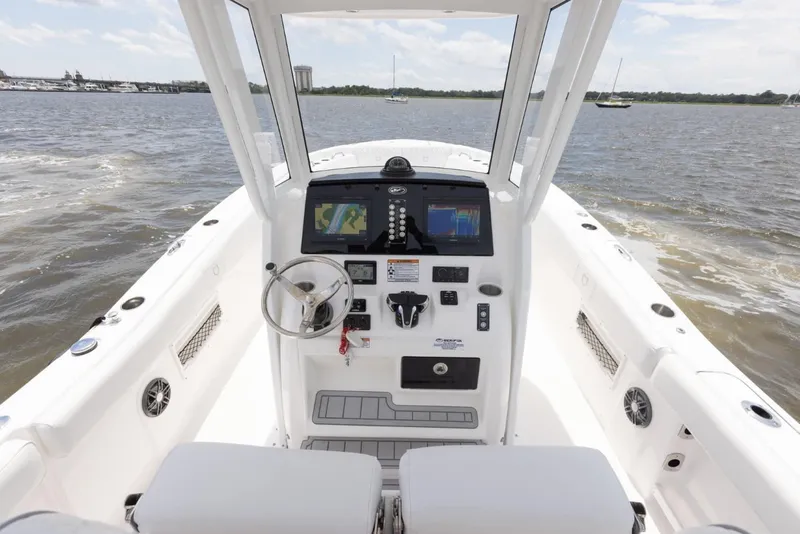 Slide: The Image of 2025 Sea Fox 268 Commander boat dashboard with navigation screens on open water. - 13