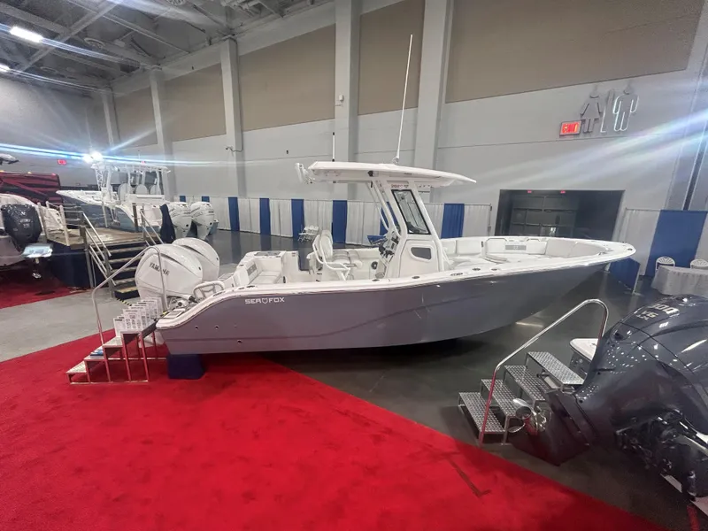 Slide: The Image of 2025 Sea Fox 268 Commander boat displayed indoors on red carpet. - 2