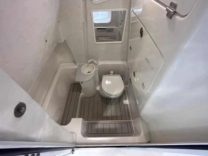 Slide: The Image of 2025 Sea Fox 268 Commander boat bathroom with toilet and mirror. - 20