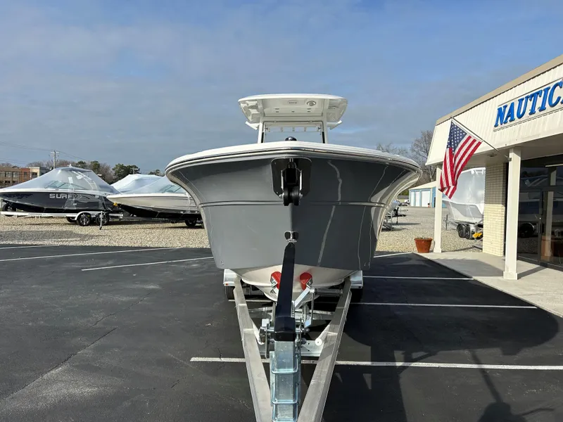 Slide: The Image of 2025 Sea Fox 268 Commander boat on trailer at dealership, American flag visible. - 5