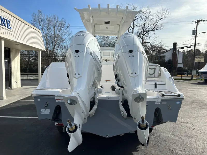 Slide: The Image of 2025 Sea Fox 268 Commander with dual outboard engines, parked outdoors. - 8