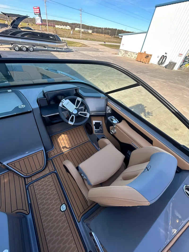 Slide: The Image of 2025 MasterCraft X26 boat interior with modern steering and luxurious seating. - 11