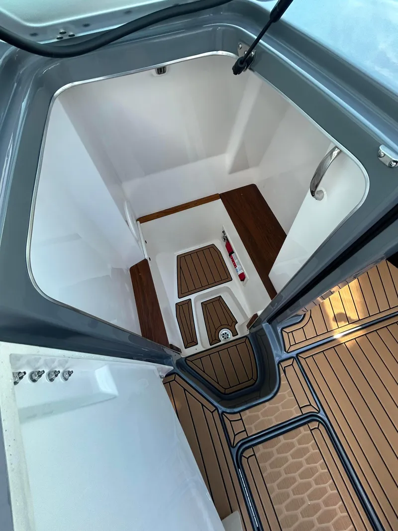 Slide: The Image of Interior view of 2025 MasterCraft X26 boat with sleek wood flooring. - 14
